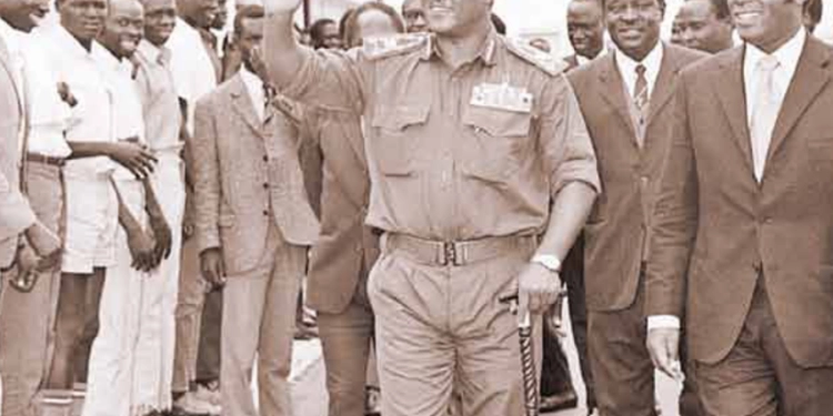 President Jafer Numeiry of Sudan waves to Sudanese students living in Kenya during a stop-over in Nairobi from Somalia on July 12, 1972. He was received by Foreign Minister Njoroge Mungai (right) and Commerce and Industry Minister Julius Gikonyo Kiano (partly hidden behind Gen Numeiry).