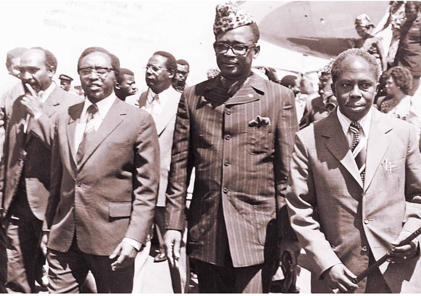 President Mobutu Sese Seko of Zaire (second right) arrives in Nairobi for a visit on December 5, 1974. He is received at the airport by Foreign Minister Munyua Waiyaki, the Minister for Commerce and Industry, Dr Gikonyo Kiano (right) and Assistant Ministers Kamwithi Munyi (third left) and Gilbert M’Mbijjiwe (left)