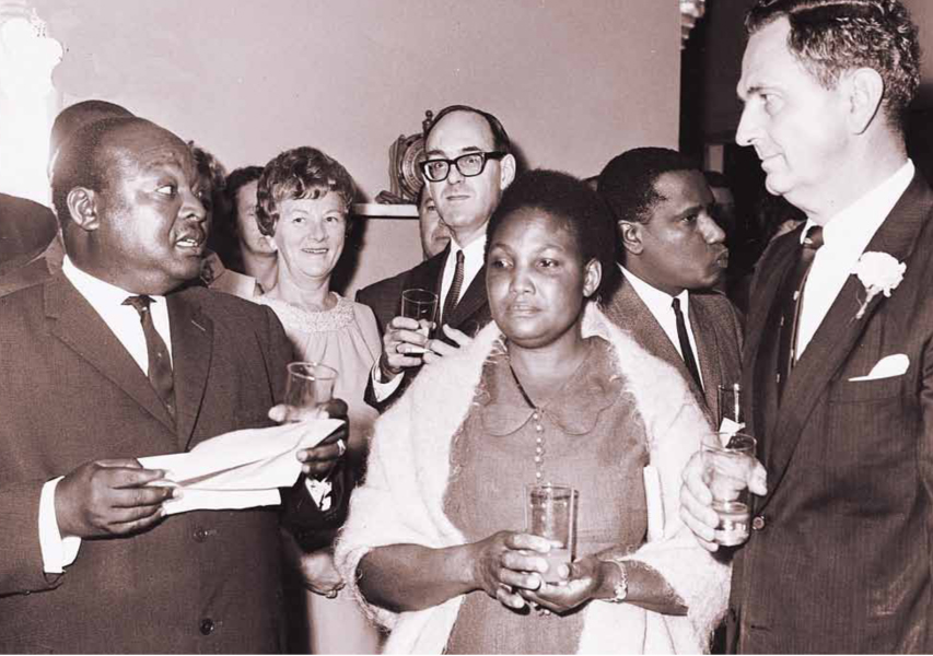 The Minister for Health, Mr Joseph D. Otiende (left), speaking on United Nations Development Programme (UNDP) day at the residence of the UNDP Representative in Kenya, Mr Steadman (right), on November 7, 1968, accompanied by Mrs Otiende (centre).