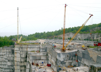 Two guy derricks at a granite quarry