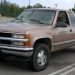A 1998 Chevrolet Silverado pickup truck parked outdoors, showcasing its classic front grille and extended cab design.