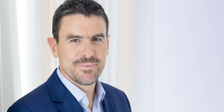 David Mignot, CEO Africa at Canal+ Group, posing in a blue suit against a light background.