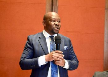 Saboti Member of Parliament Caleb Amisi speaking into a microphone during a formal meeting or event.