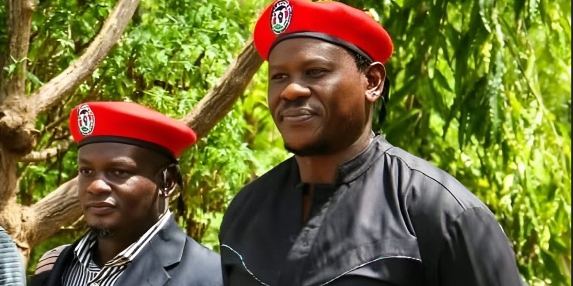 Kenyan activists Bob Njagi and Nicholas Oyoo wearing red berets during a political event in Uganda.